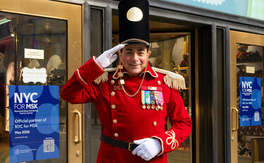 An FAO Schwarz toy soldier stands outside the store entrance in front of an NYC for MSK sign.