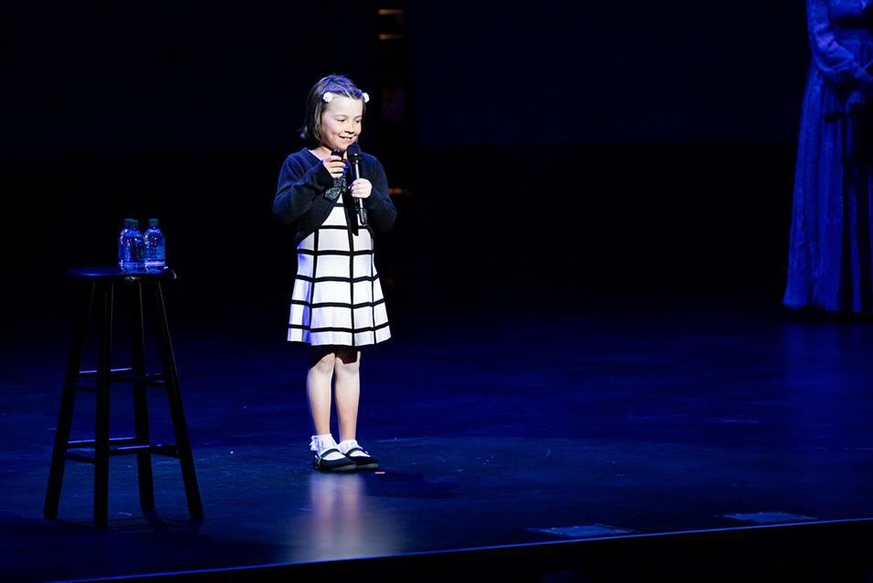 A young girl performing onstage at Comedy vs Cancer 2019   