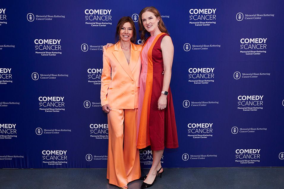 Jennifer Rogers and Niccole Kroll posing in front of the MSK backdrop at Comedy vs Cancer 2024    